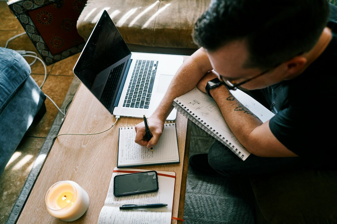 writer at desk with notebook